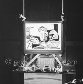 During filming of "Le mystère Picasso". Pablo Picasso working on "Nature morte". Pablo Picasso had a frame constructed on which he could stretch a transluscent piece of paper. He drew on one side, and the camera filmed the drawing being born from the other side. Nice, Studios de la Victorine 1955. - Photo by Edward Quinn