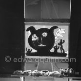 Something begun as a bouquet has become first a fish, then a cock, and finally the head of a faun. In the foreground ashtrays transformed into pots for colored inks. "Le mystère Picasso", Nice, Studios de la Victorine 1955. - Photo by Edward Quinn