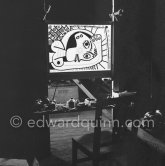 During filming of "Le mystère Picasso". Pablo Picasso working on "Tête de femme" with colored ink. He had a frame constructed on which he could stretch a transluscent piece of paper. He drew on one side, and the camera filmed the drawing being born from the other side. Nice, Studios de la Victorine 1955. - Photo by Edward Quinn