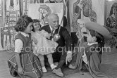 Pablo Picasso with Claude Picasso in "swashbuckler" ("cap et épée") dress. Paloma Picasso with doll. La Californie, Cannes, Christmas 1955. - Photo by Edward Quinn