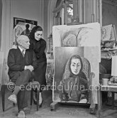 Pablo Picasso and Jacqueline with the painting "Portrait de Jacqueline au rocking-chair et à la mantille noire". La Californie, Cannes 1955. - Photo by Edward Quinn