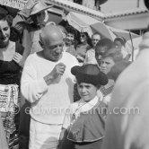 Pablo Picasso dresses up his children Paloma Picasso and Claude Picasso in miniature toreador costumes. In front of restaurant Le Vallauris. Vallauris 1955. - Photo by Edward Quinn
