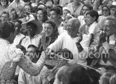On the grandstand of a bullfight put on in Pablo Picasso's honor. From left: Bandrillero andaluz Francisco Reina, "El Minuni", Javier Vilató, Jacqueline, Pablo Picasso, Jean Cocteau. Behind them Paloma Picasso, Maya Picasso and Claude Picasso. Vallauris 1955. - Photo by Edward Quinn