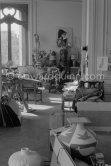 Jacqueline and Pablo Picasso at the dining and work table. Jacqueline is wearing a dress with printed motifs of a Pablo Picasso work. La Californie, Cannes 1956. - Photo by Edward Quinn