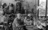 Pablo Picasso and Jacqueline. Luncheon at the dining and work table. Jacqueline is wearing a dress with printed motifs of a Pablo Picasso work. La Californie, Cannes 1956. - Photo by Edward Quinn