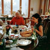 Pablo Picasso and Jacqueline. Luncheon at the dining and work table. Jacqueline is wearing a dress with printed motifs of a Pablo Picasso work. La Californie, Cannes 1956. - Photo by Edward Quinn