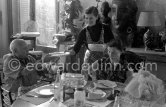 Pablo Picasso, Jacqueline and the cook. Luncheon at the dining and work table. Jacqueline is wearing a dress with printed motifs of a Pablo Picasso work. La Californie, Cannes 1956. - Photo by Edward Quinn