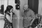 Pablo Picasso and Jacqueline at the telephone. She is wearing a dress with printed motifs of a Pablo Picasso work. La Californie, Cannes 1956. - Photo by Edward Quinn