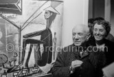 Pablo Picasso at a private viewing of his book illustrations in the Matarasso gallery in Nice. Lady (not yet identified) with a pendent by Pablo Picasso. Exposition "Pablo Picasso. Un Demi-Siècle de Livres Illustrés". Galerie H. Matarasso. 21.12.1956-31.1.1957. Nice 1956. - Photo by Edward Quinn