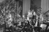 At Christmas with Esmeralda, the goat Pablo Picasso received from Jacqueline. Pablo Picasso, Inès Sassier, Pablo Picasso's housekeeper, Jacqueline, Claude Picasso, Paloma Picasso, Catherine Hutin, Gérard Sassier. La Californie, Cannes 1956. - Photo by Edward Quinn