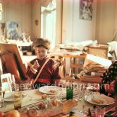 Paloma Picasso is wearing the Davy Crockett trapper outfit she received as a Christmas present. With a Yule log cake (or bûche de Noël). La Californie, Cannes 1956. - Photo by Edward Quinn