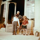 Pablo Picasso, Claude Picasso and Paloma Picasso at Christmas with Esmeralda. On the left boxer dog Jan. Paloma Picasso is wearing the Davy Crockett outfit she received as a Christmas present. La Californie, Cannes 1956. - Photo by Edward Quinn