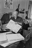 Pablo Picasso with with a book about Bernard Palissy, French potter of the 16th century. La Californie, Cannes 1957. - Photo by Edward Quinn
