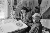 Picasso and Jacqueline viewing a book about Bernard Palissy, French potter of the 16th century. La Californie, Cannes 1957. - Photo by Edward Quinn
