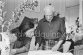Pablo Picasso and Jacqueline viewing a book about Bernard Palissy, French potter of the 16th century. La Californie, Cannes 1957. - Photo by Edward Quinn