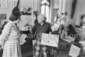 Pablo Picasso explaining Lucie Weill bullfight painting by Claude Picasso: POUR MON PAPA CHERIE CLAUDE. La Californie, Cannes 1957. - Photo by Edward Quinn
