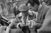 Pablo Picasso signing autograph for Lucien Clergue. Unveiling of mural "The Fall of Icarus" for the conference hall of UNESCO building in Paris. The mural is made up of forty wooden panels. Initially titled "The Forces of Life and the Spirit Triumphing over Evil", the composition was renamed in 1958 by George Salles, who preferred the current title, "The Fall of Icarus". Vallauris, 29 March 1958. - Photo by Edward Quinn