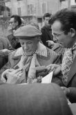 Pablo Picasso signing autograph for Lucien Clergue. Unveiling of mural "The Fall of Icarus" for the conference hall of UNESCO building in Paris. The mural is made up of forty wooden panels. Initially titled "The Forces of Life and the Spirit Triumphing over Evil", the composition was renamed in 1958 by George Salles, who preferred the current title, "The Fall of Icarus". Vallauris, 29 March 1958. - Photo by Edward Quinn