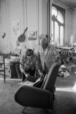 Pablo Picasso and Jacqueline viewing a new book with his works. Jacqueline is wearing a blouse made from a textile designed by Pablo Picasso. La Californie, Cannes, 1959. - Photo by Edward Quinn