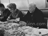 Lunch at the restaurant Blue Bar in Cannes. Pablo Picasso about to enjoy an oyster, Lucia Bosè, Louise Leiris. Cannes 1959. - Photo by Edward Quinn