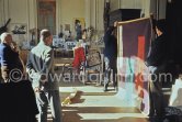 Pablo Picasso, Michel Leiris, Pierre Baudouin and Paulo Picasso with tapestry "Les clowns à la lune bleue", La Californie, Cannes 1959. - Photo by Edward Quinn