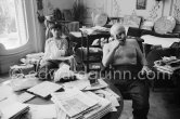 In a corner of his villa Pablo Picasso sits quietly with his son Claude Picasso, on the table a pile of english newspapers reporting on his London exhibition. La Californie, Cannes 1960. - Photo by Edward Quinn