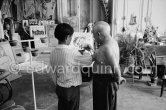 Pablo Picasso introduces Claude Picasso to a new pet, a talking parrot, which is squatting on his arm. La Californie, Cannes 1960. - Photo by Edward Quinn