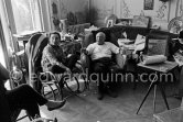 Pablo Picasso and Jacqueline. Jacqueline, sitting in a rocking chair, is wearing a blouse made from a textile designed by Pablo Picasso. La Californie, Cannes 1961. - Photo by Edward Quinn