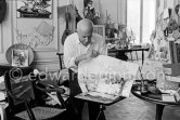 Pablo Picasso working on gouache with Caran d'ache wax oil pastels and water color. Pablo Picasso always liked surprises and in his work he encouraged unpredictable outcomes. here he has used an old drawing paper due to blot the wet gouache and examines the results with interest. La Californie, Cannes 1961. - Photo by Edward Quinn