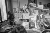 Pablo Picasso at La Californie. The proverbial disorder of the rooms in which Pablo Picasso works is unique. Beside the large pieces of sculpture in painted iron and plaster hang portraits of Jacqueline and Paloma Picasso surrounded by drawings, objects and notes pinned to the wall. La Californie, Cannes 1961. - Photo by Edward Quinn