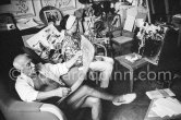 Pablo Picasso and Jacqueline viewing photos by Edward Quinn (Pic610195), which the latter brought as a gift. Jacqueline is wearing a blouse made from a textile designed by Pablo Picasso. La Californie, Cannes 1961. - Photo by Edward Quinn