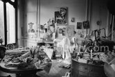 The proverbial disorder of the rooms in which Pablo Picasso works is unique. Beside the large pieces of sculpture in painted iron and plaster hang portraits of Jacqueline and Paloma Picasso surrounded by drawings, objects and notes pinned to the wall. La Californie, Cannes 1961. - Photo by Edward Quinn
