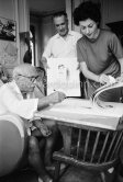Pablo Picasso signing his lithograph of Rimbaud. With Henri Matarasso and his niece. La Californie, Cannes 1961. - Photo by Edward Quinn