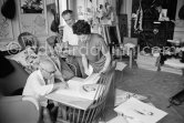 Pablo Picasso signing Rimbaud litho. With Henri Matarasso and his niece. La Californie, Cannes 1961. - Photo by Edward Quinn