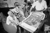 Pablo Picasso and Henri Matarasso, gallery owner and publisher, checking the etching "La Minotauromachie". La Californie, Cannes 1961. - Photo by Edward Quinn
