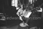 Pablo Picasso with the book "Pablo Picasso at Work" by Edward Quinn, dedicated by Pablo Picasso and Edward Quinn "Pour Jacqueline Kennedy". In the background TV-table by Tiola. Mas Notre-Dame-de-Vie, Mougins 1964. - Photo by Edward Quinn