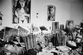 Large sofa weighed down with an array of papers, prints, tennis rackets, the book "Pablo Picasso at Work" by Edward Quinn on the table. Mas Notre-Dame-de-Vie, Mougins 1964. - Photo by Edward Quinn
