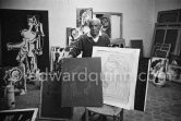 In his studio at Mas Notre-Dame-de-Vie, Pablo Picasso shows for comparison his original linoleum block for "Portrait of Jacqueline" and a linocut print made from it. Mas Notre-Dame-de-Vie, Mougins 1964. - Photo by Edward Quinn