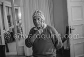 To strike a pose, Pablo Picasso tries on hats from his collection for his own amusement and that of his guests. Mas Notre-Dame-de-Vie, Mougins 1964. - Photo by Edward Quinn