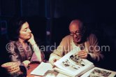 Pablo Picasso and Jacqueline viewing the layout of the newest "Le Zervos", the catalogue raisonné of the works of Pablo Picasso. One of the last photos of Pablo Picasso by Edward Quinn. Mas Notre-Dame-de-Vie, Mougins 7. Jan 1972. - Photo by Edward Quinn