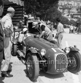 During filming of "The Racers": Louis Chiron, John Fitch who did the driving stunts for Kirk Douglas in the HWM Alta, director Henry Hathaway (with hat). The car, ex-Stirling Moss, which was later turned into the Stovebolt Special after MGM sold the cars off when filming finished. Owner Simon Taylor. Monaco 1954. - Photo by Edward Quinn