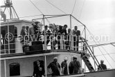 Grace Kelly and Prince Rainier on his yacht Deo Juvante II. She came ashore from the liner S.S. Constitution, which brought her to Monaco for her marriage. Her mother Margaret in the background left. Monaco 1956. - Photo by Edward Quinn