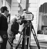 Director Jean Renoir checks a camera angle. Place unknown, early '50s. - Photo by Edward Quinn