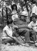 Jean Renoir in the gardens of "Les Collettes" (today Musée Renoir) directing  the film “Le Déjeuner sur l’herbe”. Behind him actress Catherine Rouvel. Cagnes-sur-Mer 1959. - Photo by Edward Quinn