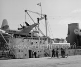 "Olympic Whaler", the whaling ship of Aristotle Onassis. With Italian twin-engine amphibian flying boat I-FIMA, prototype of Piaggio P-136. Nice harbor 1952. - Photo by Edward Quinn