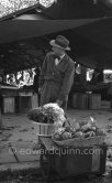 Georges Simenon on a market in Cannes 1955. - Photo by Edward Quinn