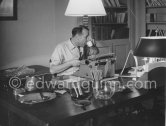 Georges Simenon at his desk. Villa Golden Gate, Cannes 1955. - Photo by Edward Quinn