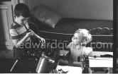 George Simenon's children Marie-Jo (2) and Jean (6) playing with their father's tobacco pipes. Villa Golden Gate, Cannes 1955. - Photo by Edward Quinn