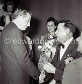 Jules Dassin, American film and theatre director, producer, writer and actor, greeting Georges Simenon. Simenon's wife in the background. Cannes Film Festival 1955 - Photo by Edward Quinn