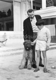 Georges Simenon with his poodle Mister and Charlie Chaplin's son Michael Chaplin at his Villa Golden Gate. Cannes 1955 - Photo by Edward Quinn